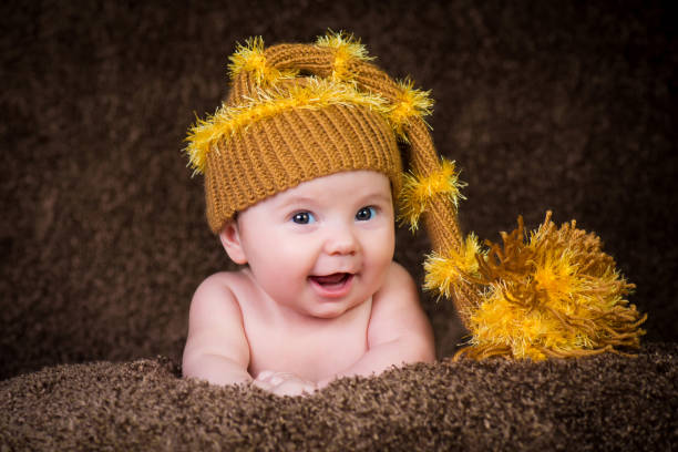 istock Newborn in knitted winter hat on a beige background. 636519534