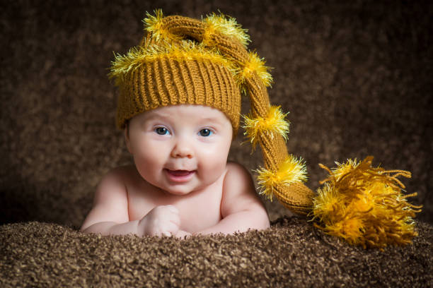 istock Newborn in knitted winter hat on a beige background. 636519634