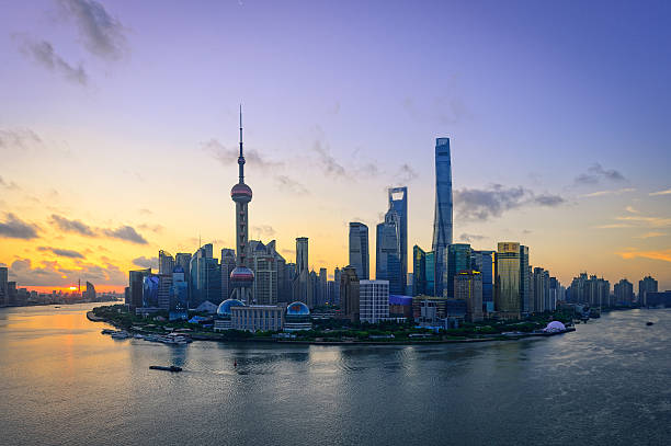 istock Waterfront cityscape and illuminated skyline at dawn 636519732