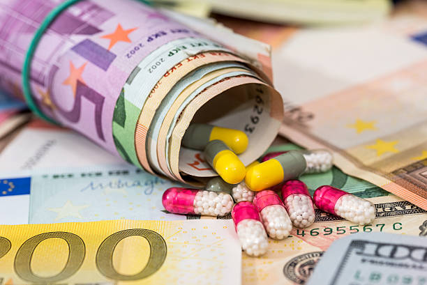 istock Pharmaceutical business. euro banknotes with pills. 636520002