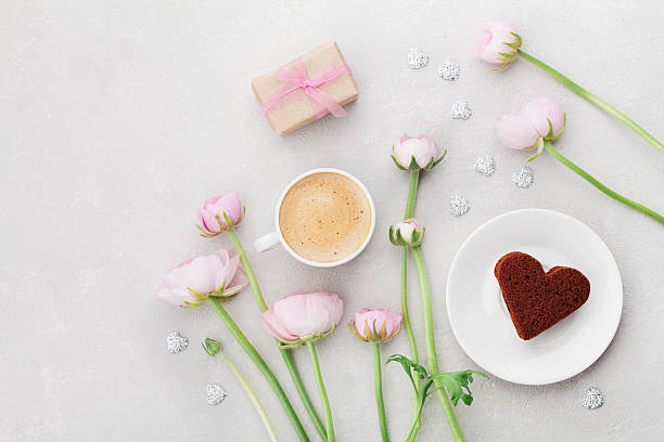 Valentines breakfast with coffee, gift, flowers, cake heart. Flat lay.