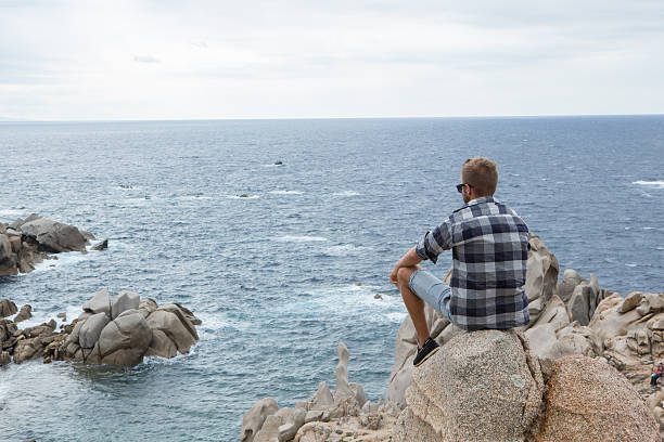 istock One young man relaxing by the sea 636523922