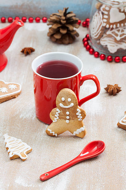 istock Tea, ginger man cookie and and red spoon on plywood background. 636524076