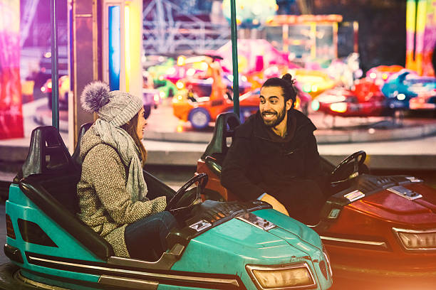 istock Couple Having Fun Riding Bumper Cars. 636524306