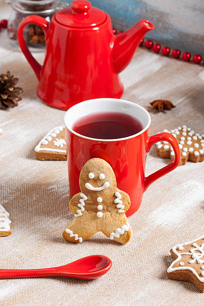 istock Tea, ginger man cookie and and red spoon on plywood background 636524632