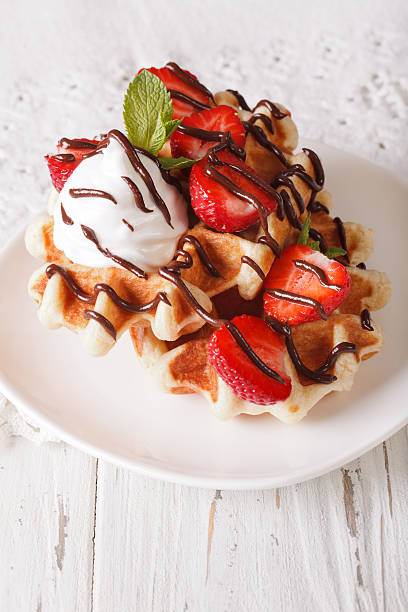 istock Belgian waffles with strawberries, whipped cream and chocolate 636524916