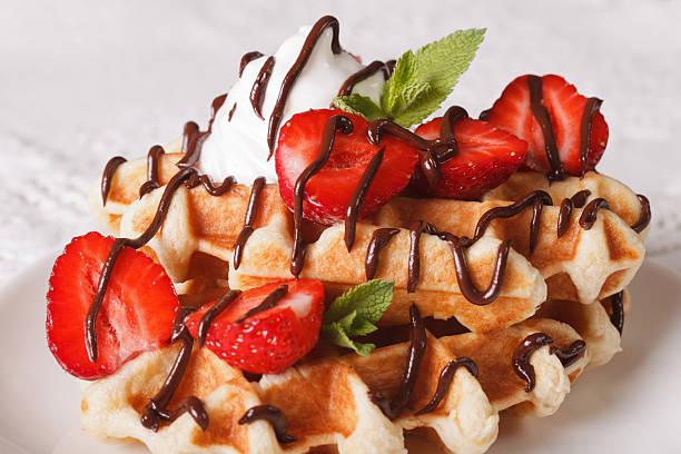 istock Belgian waffles with strawberries, whipped cream and chocolate 636525022