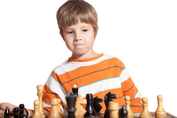 istock Portrait of a little boy playing chess 636525390