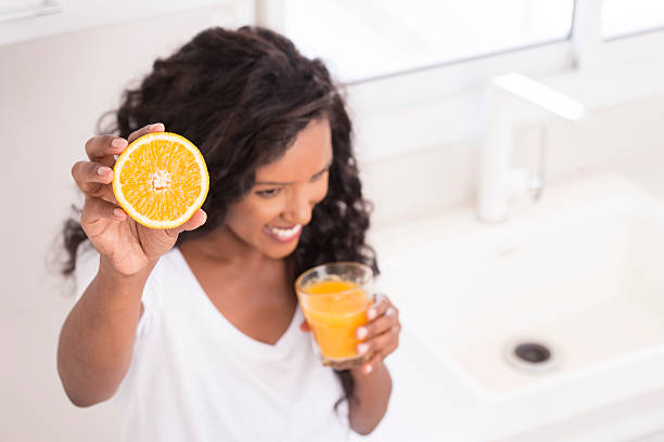 Woman drinking fresh orange juice.