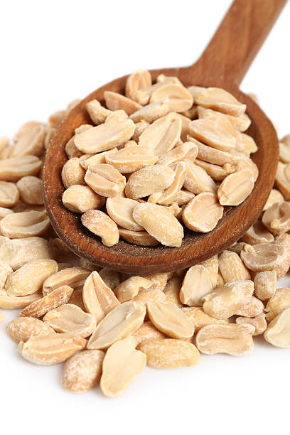 istock Roasted unsalted shelled peanuts on wooden spoon 636526224