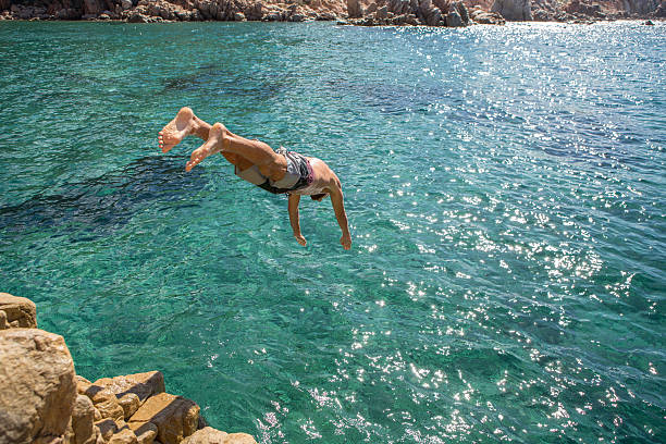 man diving into sea.