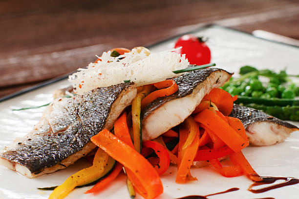 istock Grilled fish fillet with carrot close-up 636527504