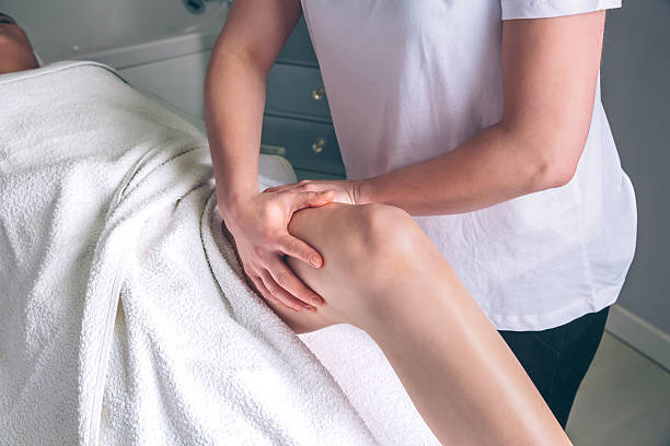 istock Massage therapist hands doing lymphatic drainage treatment to woman 636529038