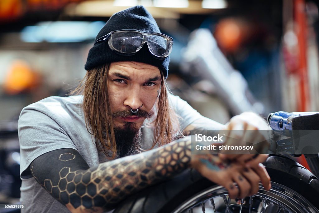 Hipster man Unshaven hipster in beanie hat looking at camera Tattoo Stock Photo