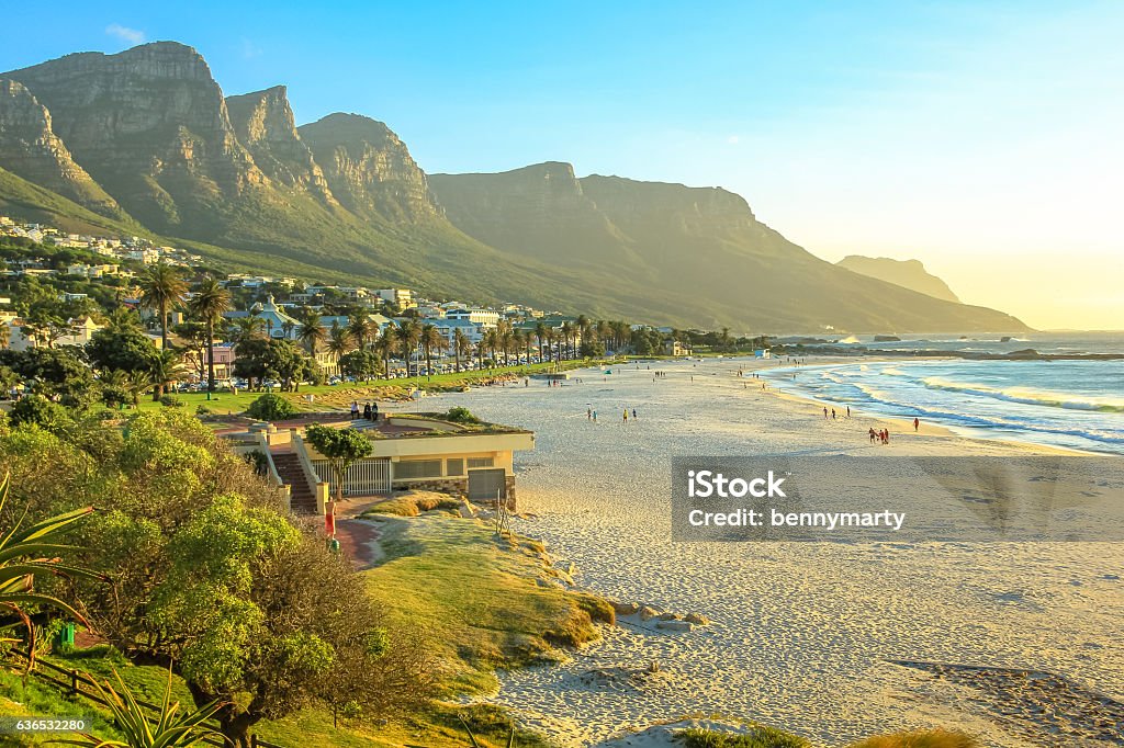 Camps Bay at sunset White long and spectacular beach of Camps Bay with Table Mountain National Park behind him in Cape Town, South Africa, Atlantic Ocean view. Shot taken at sunset. Camps Bay Stock Photo