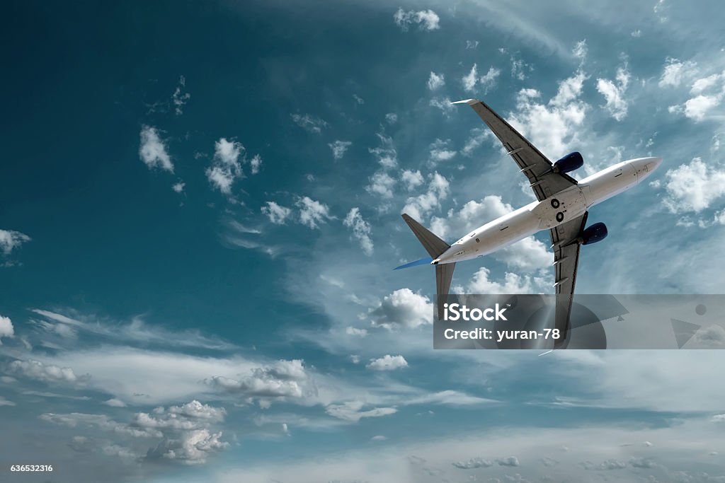 Airplane at fly on the sky with clouds Aerospace Industry Stock Photo