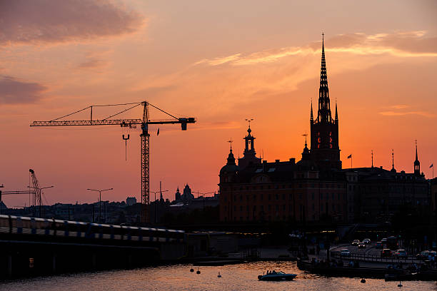 flèches de stockholm et grues de construction au coucher du soleil - runabout photos et images de collection