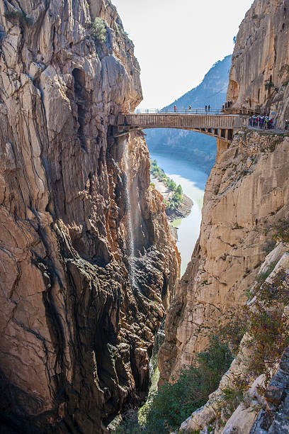istock Visitors crossing the suspension bridge at Caminito del Rey Path 636536188
