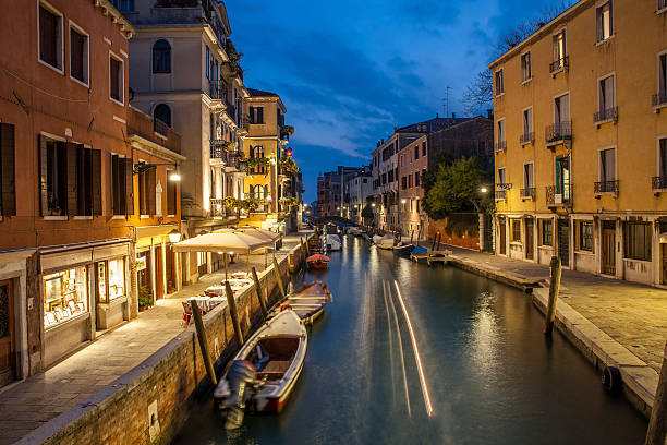 istock boats stand at pier in night Venice 636538324