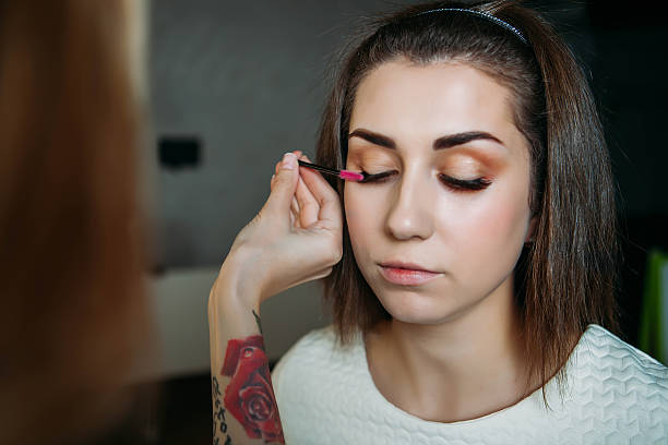 istock Beautiful model having powder applied by makeup artist 636542668