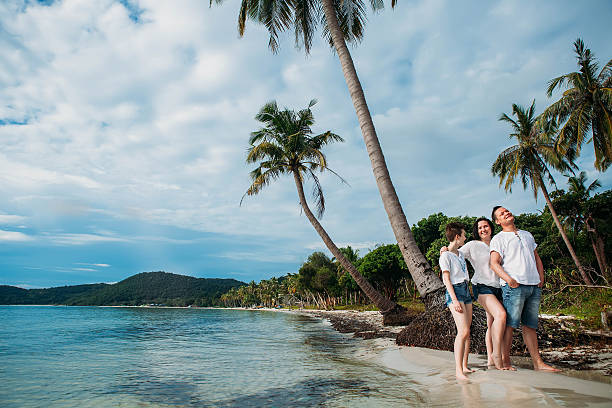 istock Family stand on tropical palm beach 636542980