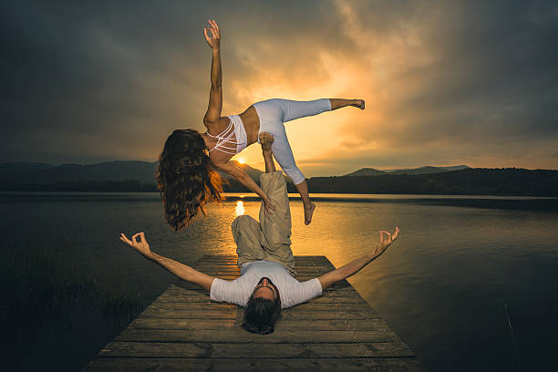 istock Acroyoga side star pose at sunset 636545390