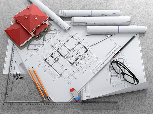 istock Scale model of house and architectural blueprints. 636545466