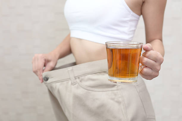 Successful woman on diet Woman on diet with oversized pants kyushu photos stock pictures, royalty-free photos & images
