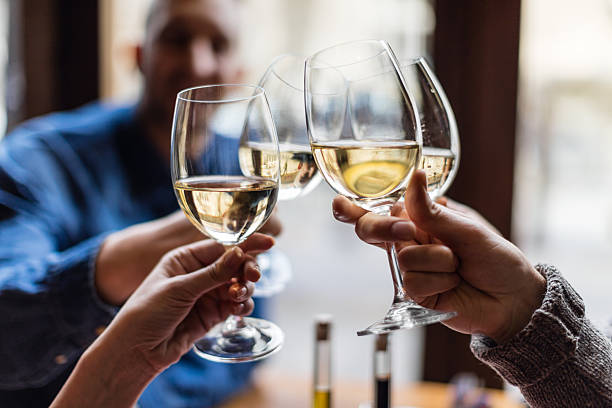 group of friends toasting with wine glasses - wine cheers bildbanksfoton och bilder