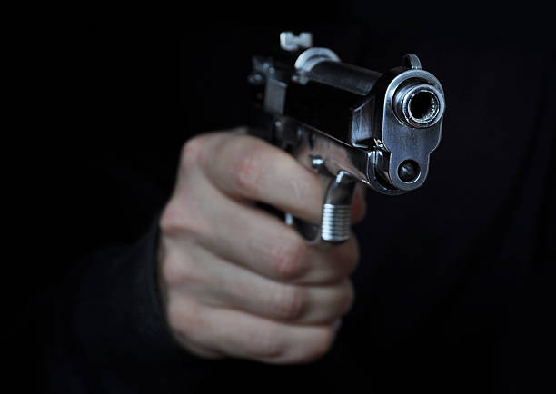 Shooting a gun Shooting a gun in night shooting stock pictures, royalty-free photos & images