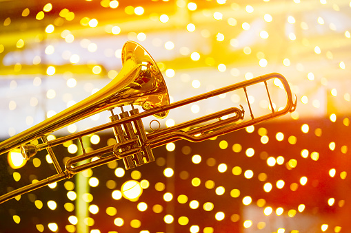 Trumpet music with lights in abstract background. The lights are actually colorful and bright Christmas lights in the distance.