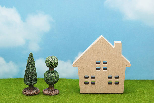 istock House on green grass over blue sky and clouds. 636553814