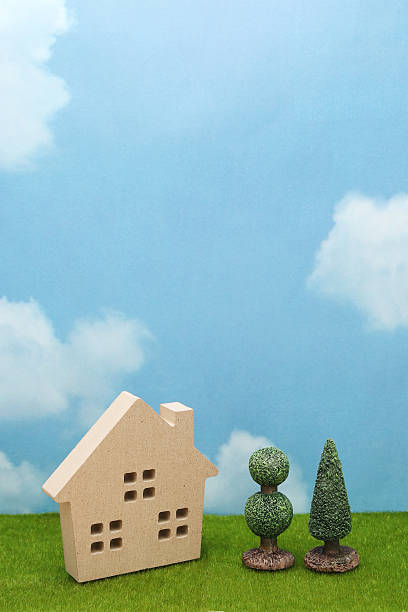 istock House on green grass over blue sky and clouds. 636553922