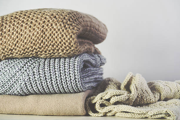 istock tinted image warm sweaters are stacked on the table 636557056