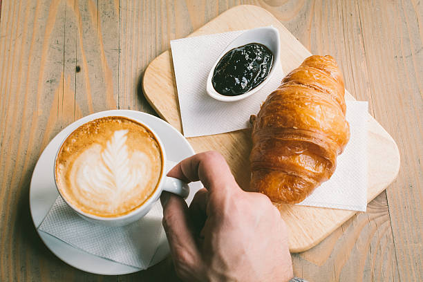 istock Coffee and Croissant on a wooden table 636557534
