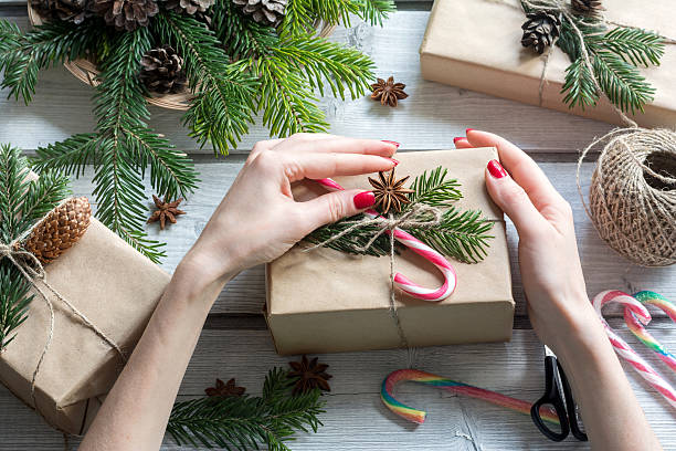 istock Woman's hands decorating gift boxes candy cane and star anise 636558944