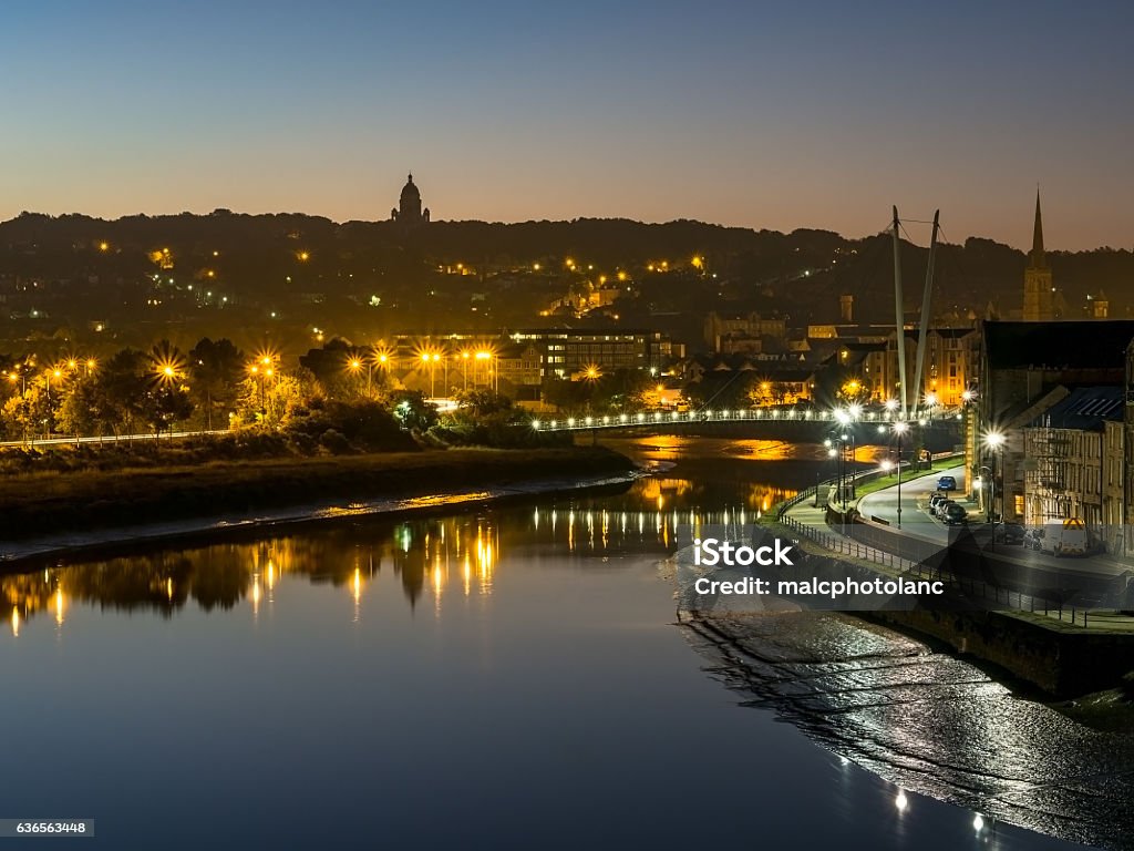 Lancaster City at dawn with lights sparkling Taken at dawn from Carlisle Railway footbridge looking down River Lune with Ashton Memorial on skyline and Millenium footbridge lights in centre of image Lancaster - Lancashire Stock Photo