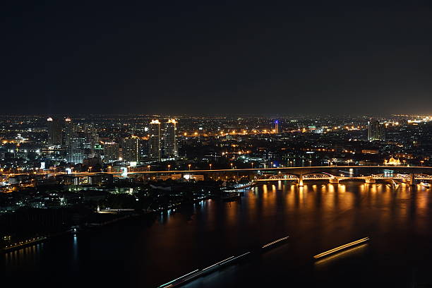 istock Bangkok city river side at night ,bird eye view 636564578