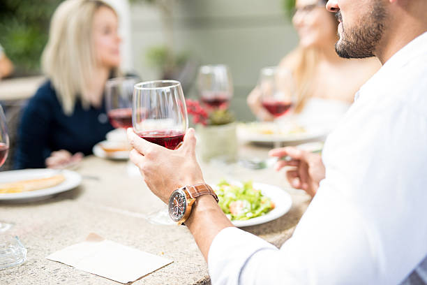 istock Young man drinking some wine with friends 636564908