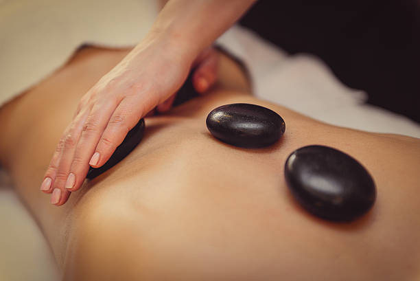 istock Skillful beautician undergoing massage for woman 636565954