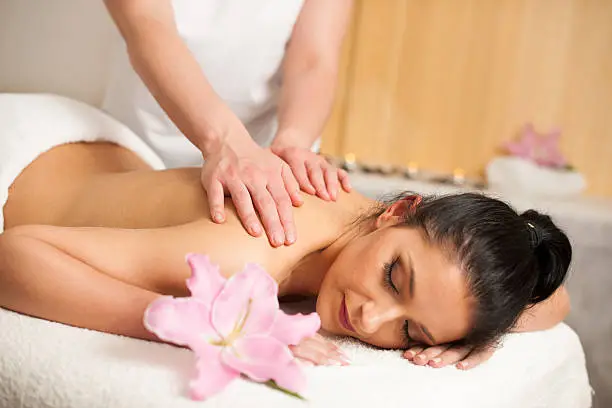 Beautifulyoung woman having a rejuvenating massage in a wellness studio - spa