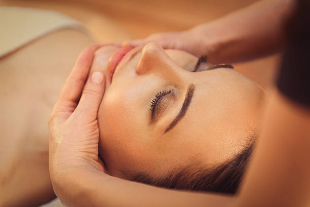 istock Skillful beautician undergoing facial massage 636567476