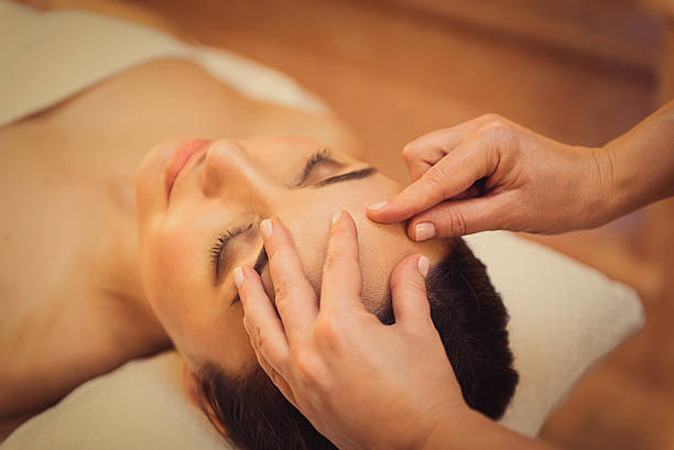 istock Beautician doing facial massage for client 636567740