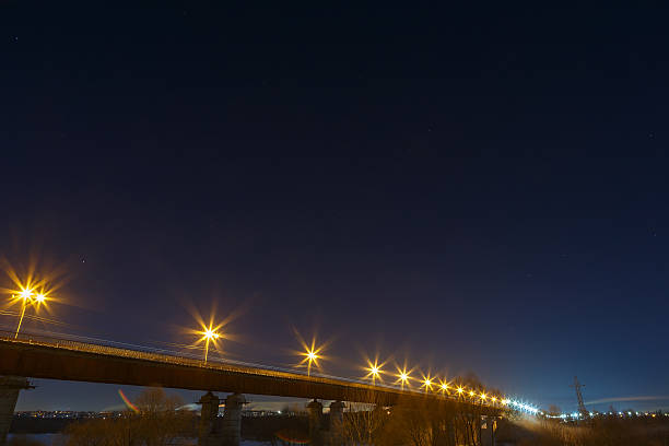 istock Highway bridge with a starry sky, lit by lanterns. 636568358