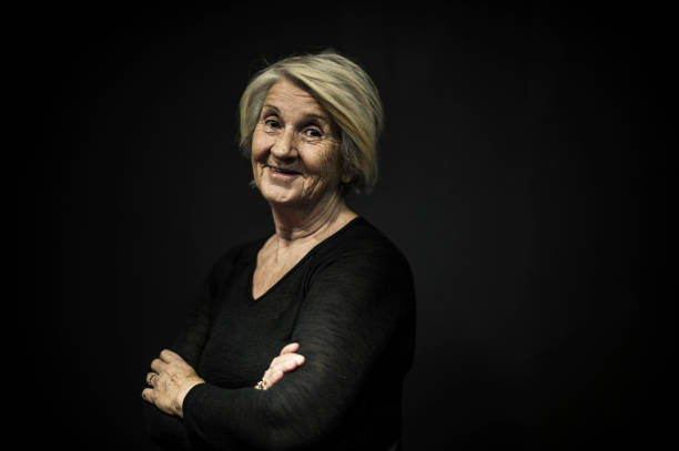 istock Senior Woman Posing Front of a Black Wall 636571686