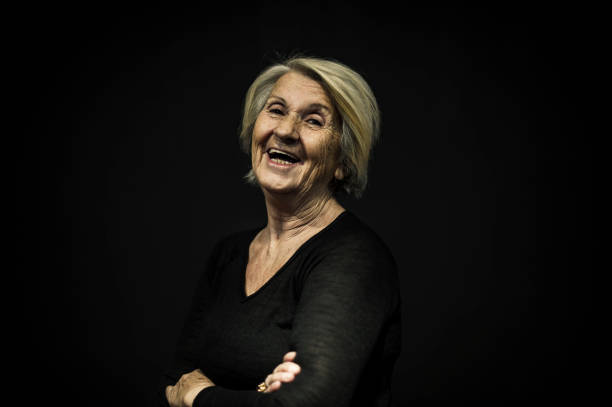 istock Senior Woman Posing Front of a Black Wall 636571752
