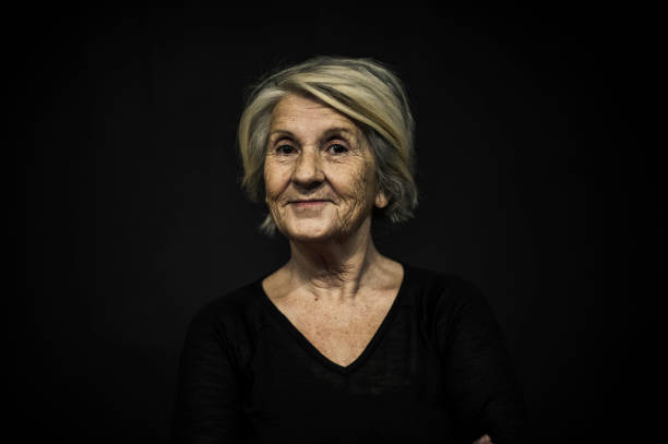 istock Senior Woman Posing Front of a Black Background 636572184