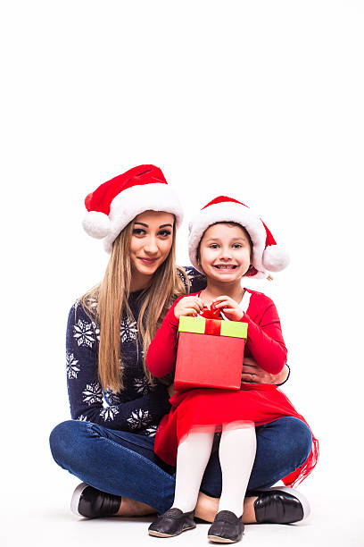 istock Mother with her daughter in Christmas hat 636572502