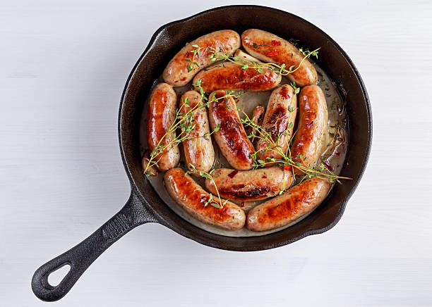 istock Home-made Pork Sausages in rustic pan with thyme 636575644