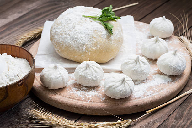 istock Raw khinkali in the kitchen. The process of preparing hinkaley 636576860